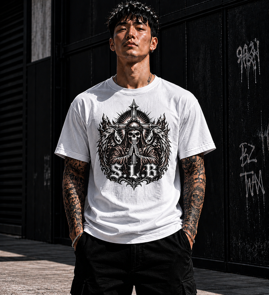 White SLB Guardian Reaper T-Shirt with winged skull, praying hands, crossed swords, and radiant crest design symbolizing faith and strength
