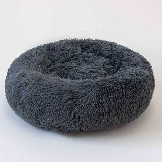 gray plush pet sleep bed with anti-skid bottom on wooden floor